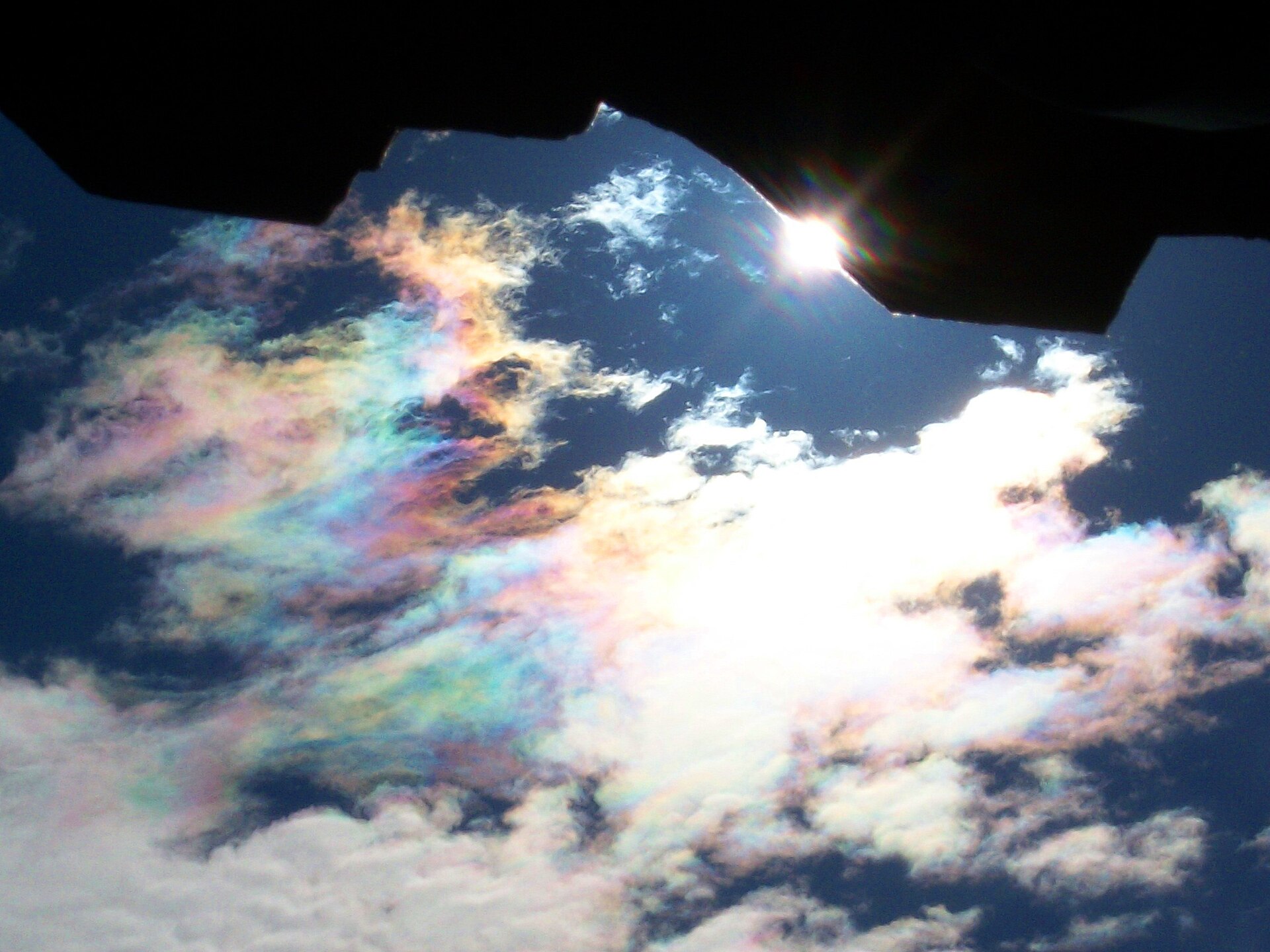Highly iridising altocumulus showing diffraction colours Iridescent pastel colours along the edge of a thin altocumulus cloud near the Sun