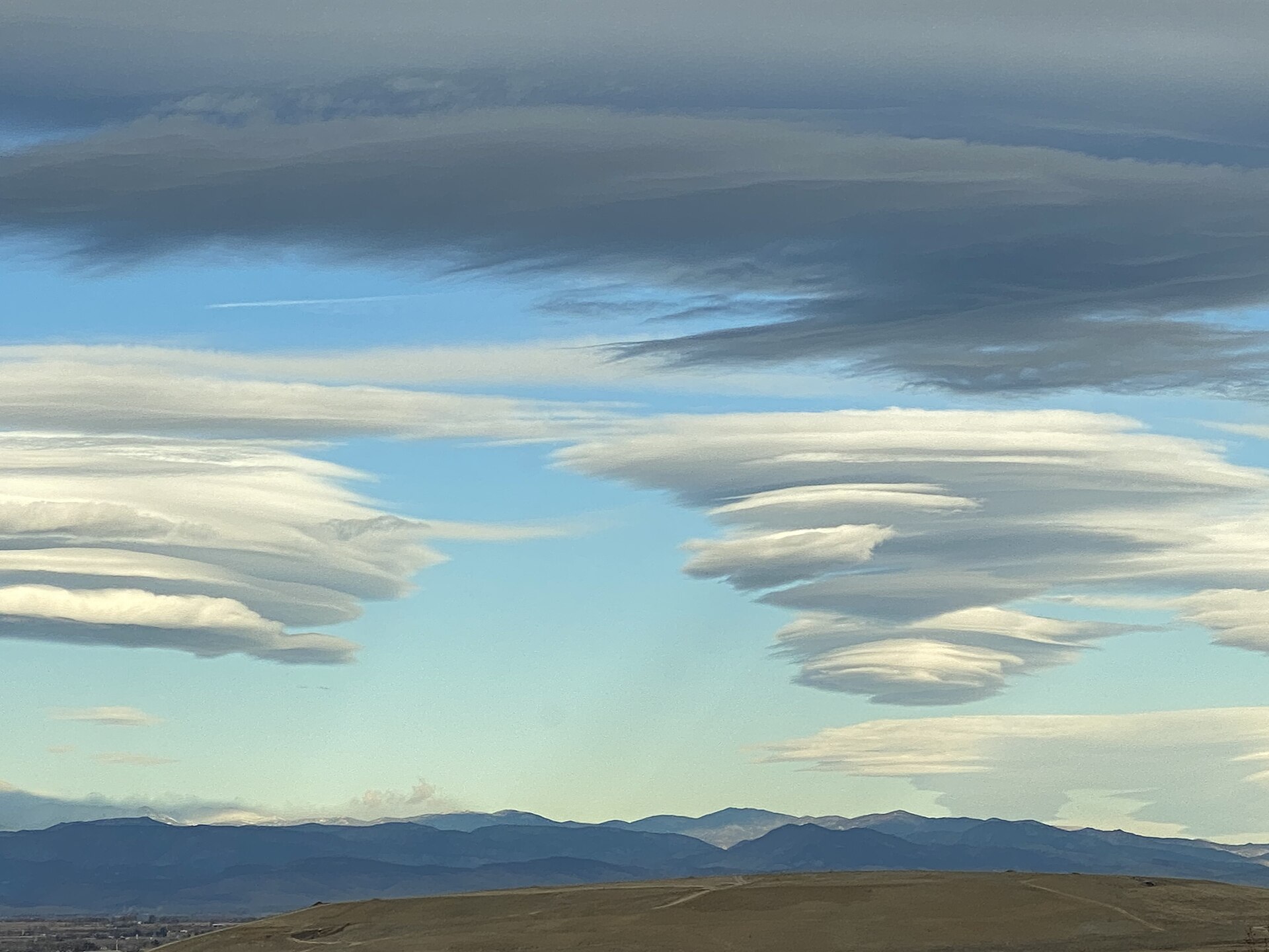 Multiple lenticular clouds Australia observers spot over the Snowy Mountains.