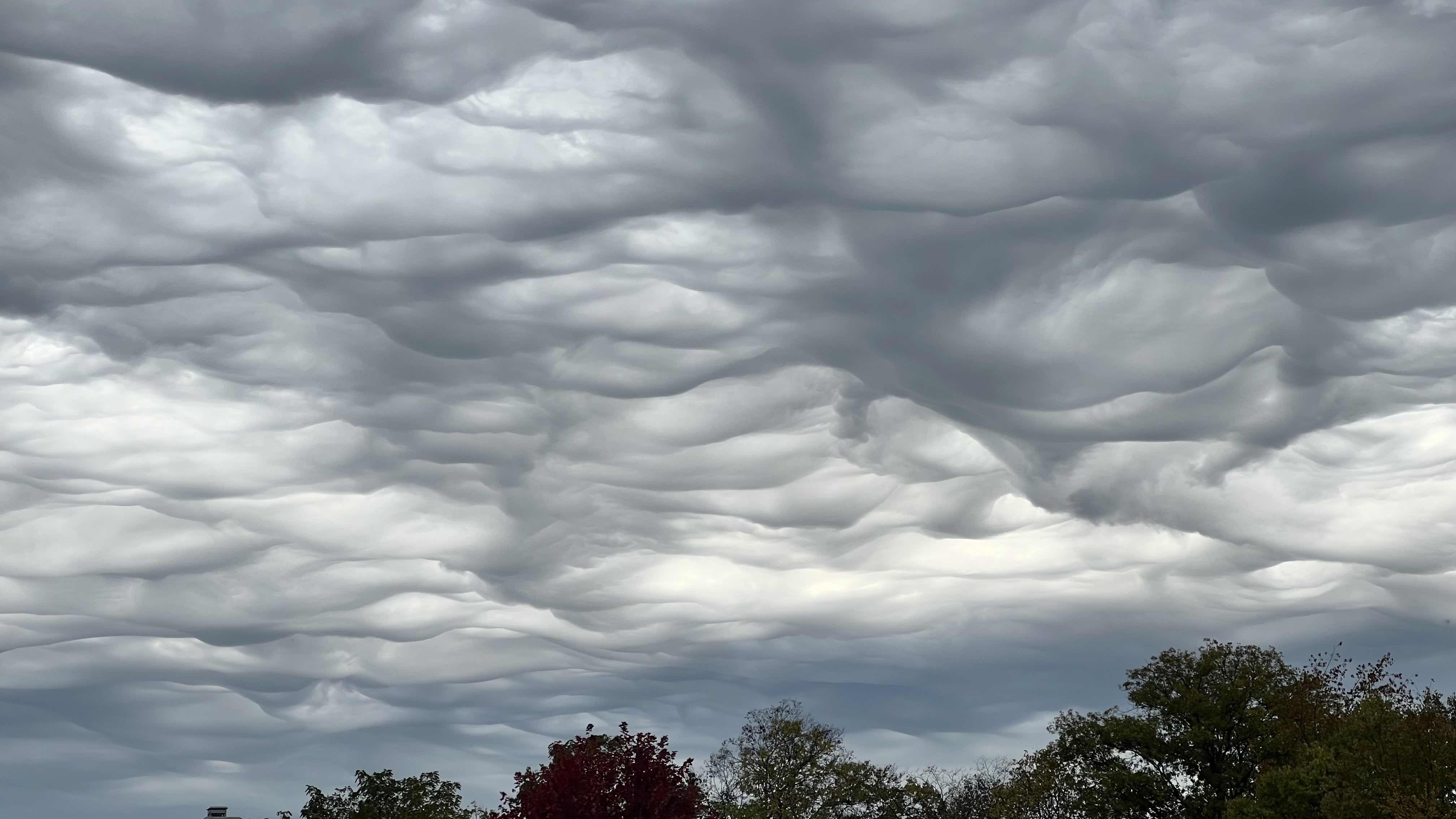 Asperitas clouds with a turbulent, wave-like underside resembling a stormy sea Asperitas clouds with a turbulent, wave-like underside resembling a stormy sea