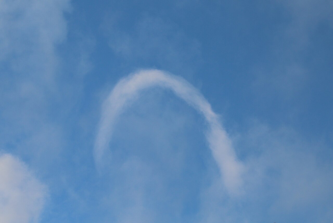 Witness a rare horseshoe vortex cloud against a blue sky, illustrating this unique Australian atmospheric phenomenon. Witness a rare horseshoe vortex cloud against a blue sky, illustrating this unique Australian atmospheric phenomenon.