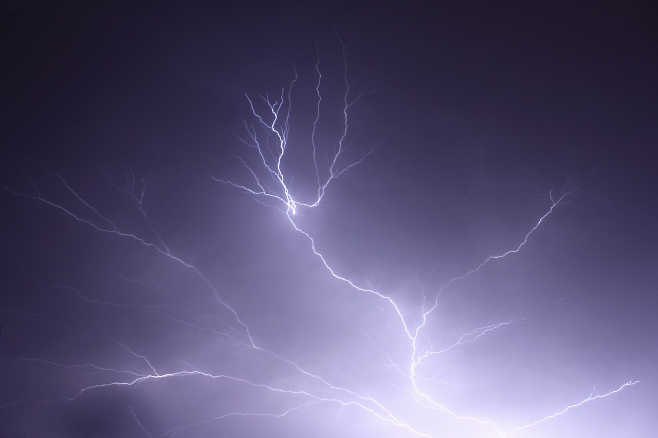 Bright, branching cloud-to-cloud lightning illuminates a dark, stormy sky, showcasing a type of atmospheric lightning. Bright, branching cloud-to-cloud lightning illuminates a dark, stormy sky, showcasing a type of atmospheric lightning.