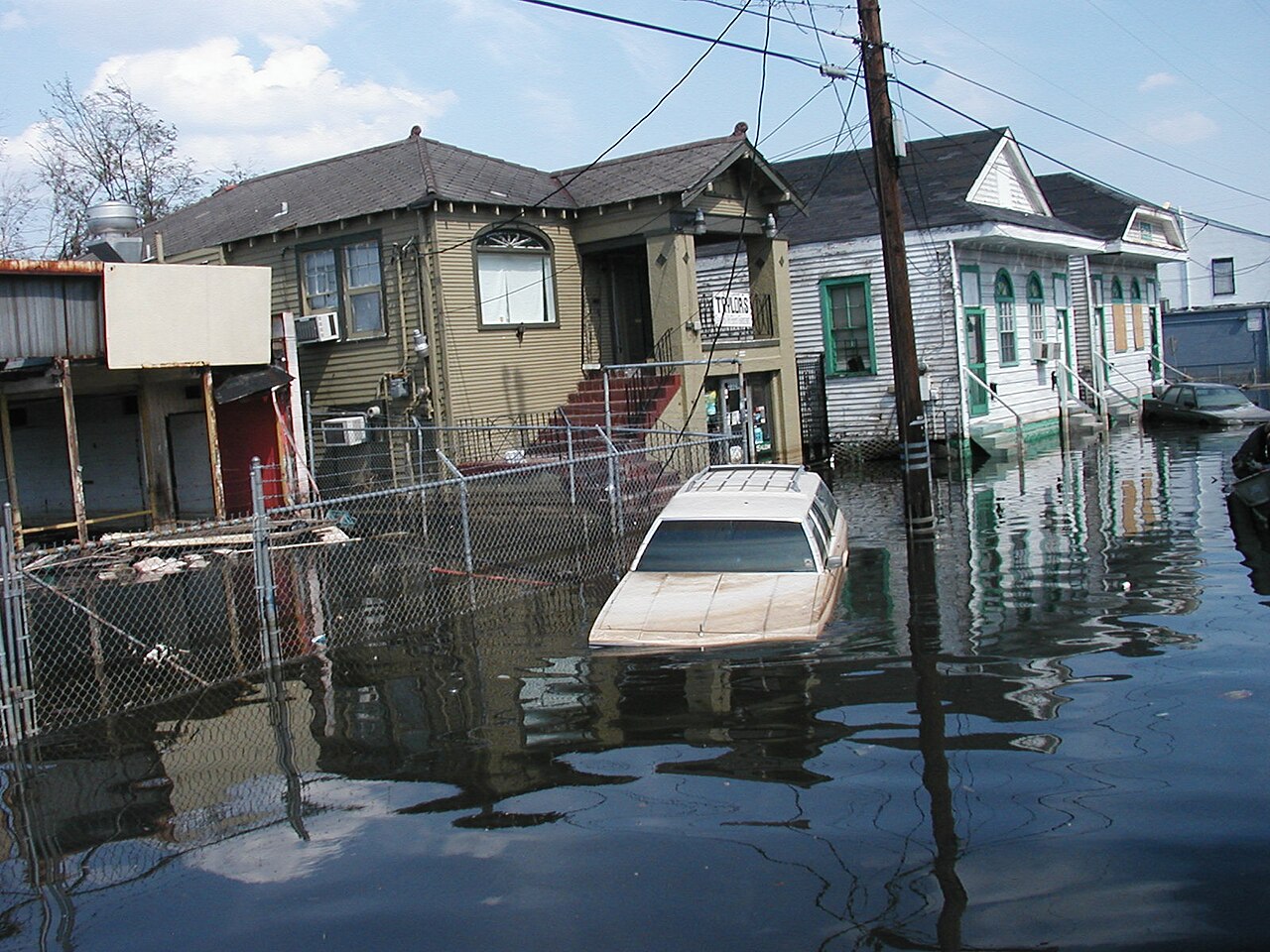 Flooded New Orleans street with submerged cars and houses, showing the catastrophic failures of Hurricane Katrina. Flooded New Orleans street with submerged cars and houses, showing the catastrophic failures of Hurricane Katrina.