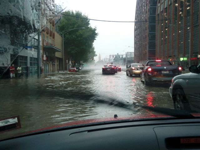 Melbourne street flooded with cars and pedestrians during the March 2010 hailstorm, showing severe urban flooding. Melbourne street flooded with cars and pedestrians during the March 2010 hailstorm, showing severe urban flooding.