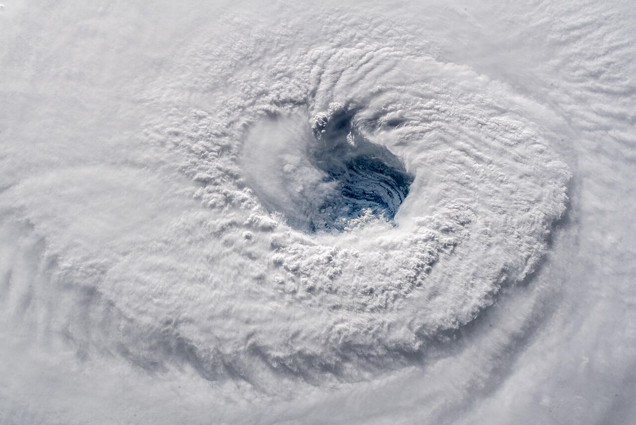 Satellite view of a powerful hurricane, its swirling white clouds and clear eye illustrating how these storms form. The eye and surrounding clouds of Hurricane Florence seen from the International Space Station.