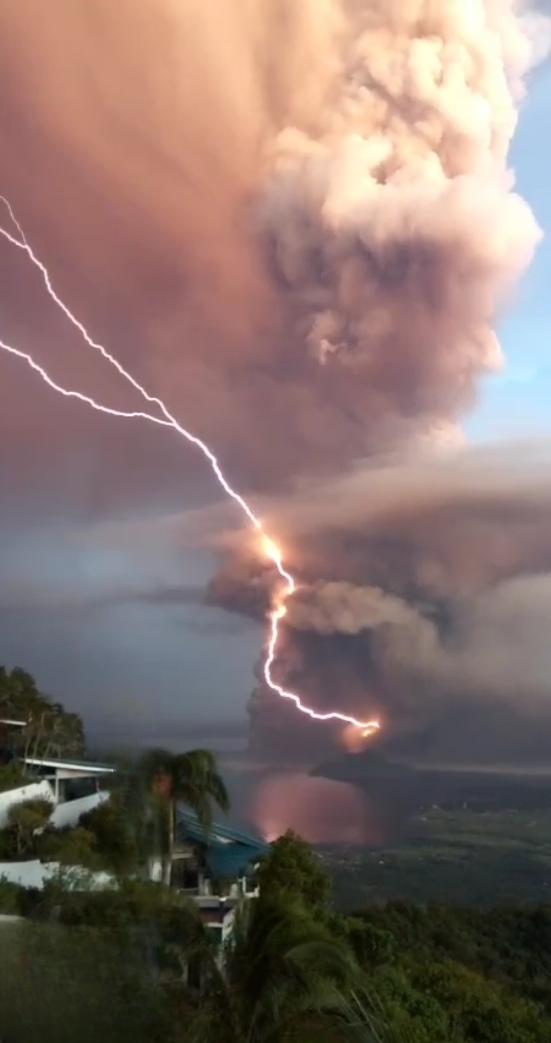 Volcanic lightning strikes through a towering ash cloud during an eruption, illustrating ash cloud electrification. Volcanic lightning strikes through a towering ash cloud during an eruption, illustrating ash cloud electrification.